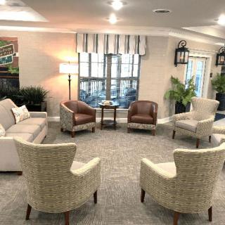 A cozy living room with arranged seating and warm lighting.