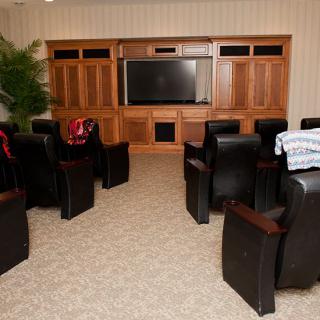 A cozy home theater setup with comfortable seating and a large screen.