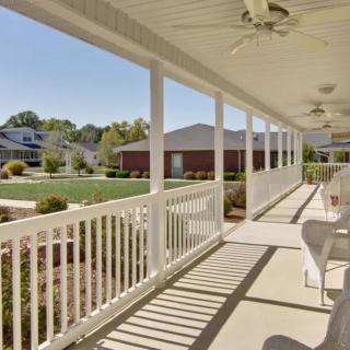 A spacious porch overlooking a well-maintained suburban neighborhood.