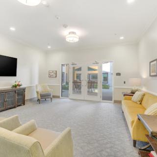 A modern and inviting living room space featuring comfortable seating and bright, airy design.