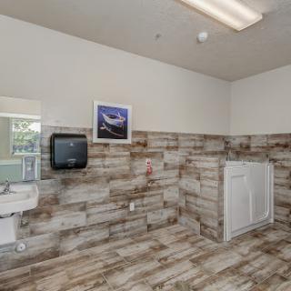 A modern laundry room featuring wood paneling and essential appliances.