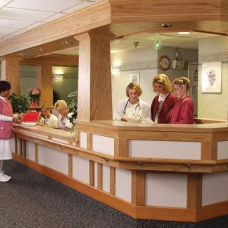 Medical staff working at a hospital reception desk.