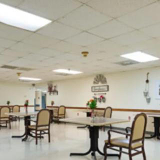 An empty dining area with tables and chairs arranged neatly.