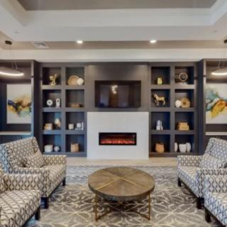 A modern living room with stylish furniture and a fireplace.