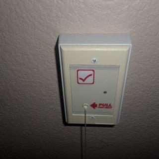 A wall-mounted emergency call button.