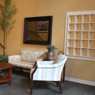 A cozy living room setup featuring a sofa, armchair, and decorative elements.
