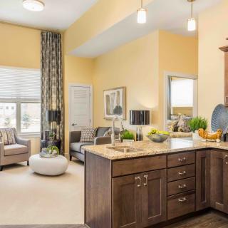 A modern open-concept living space with a kitchen and seating area.