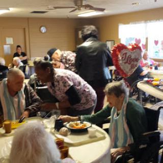 A vibrant gathering at a care center where residents enjoy meals and socialize together.