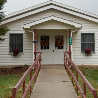 A charming house with a welcoming entrance and accessible ramp.