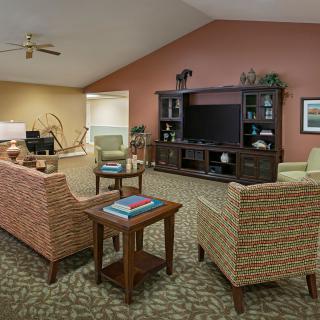 A cozy living room with comfortable seating and an entertainment center.