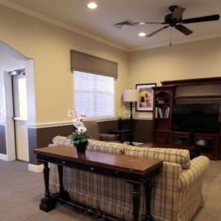 A cozy living room with a sofa, coffee table, and an entertainment center.