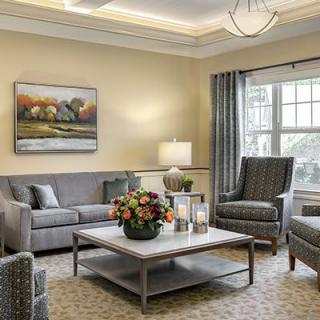 A cozy and elegantly designed living room with a neutral color palette, featuring comfortable seating and stylish decor.