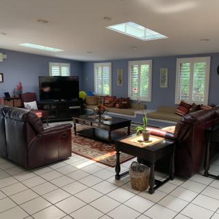 A spacious living room with ample seating and natural light.