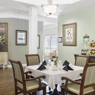 An elegantly decorated dining room with a table set for four people.