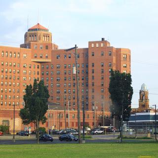 A view of a large, historic hospital building with an impressive architectural design.