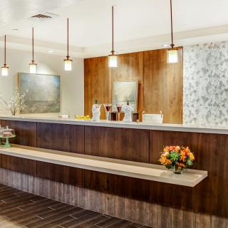 A modern hotel reception area with a stylish front desk and contemporary lighting.