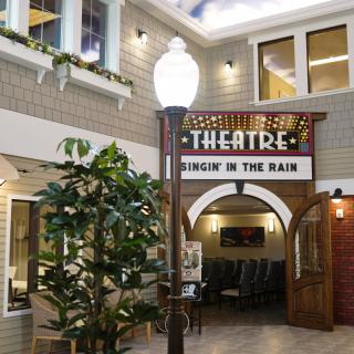 Indoor theatre entrance with vintage marquee sign and decorative elements.