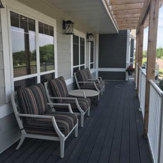 A cozy porch with chairs and a table, perfect for relaxation.