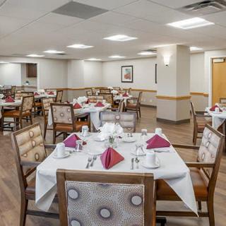 A neatly arranged dining room with tables set for service.