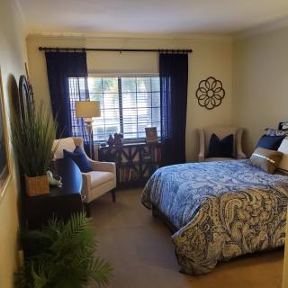 Cozy bedroom with stylish decor and natural light.
