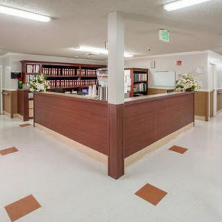 A welcoming reception area with wooden furniture and floral decorations.