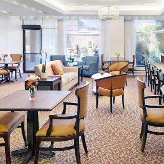 A cozy lounge area with tables and chairs arranged for comfort.