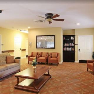 A cozy living room with a sofa, chairs, and a coffee table.