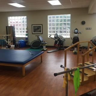 A well-equipped physical therapy room with various rehabilitation tools and exercise equipment.