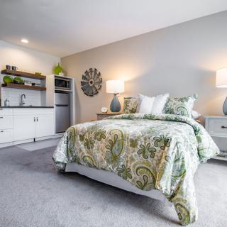 A modern and cozy bedroom with stylish bedding and ambient lighting.
