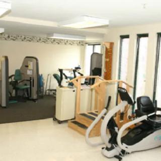 An interior view of a fitness center with various exercise equipment.