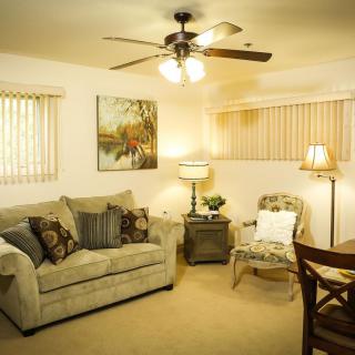 A cozy living room with a sofa, artwork, and warm lighting.