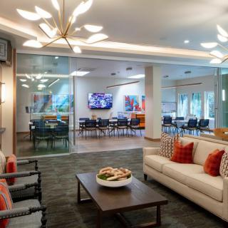 Modern living space with comfortable seating and an adjacent conference area.