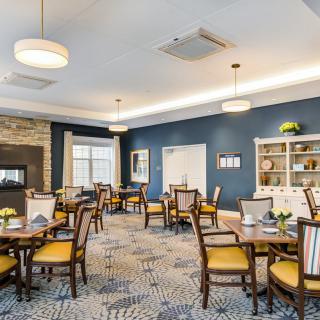 A well-furnished dining area with elegant chairs and tables, stylish lighting, and tasteful decor.