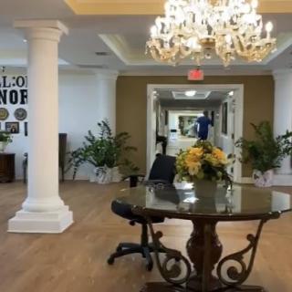 Elegant lobby area with a chandelier and decorative table centerpiece.
