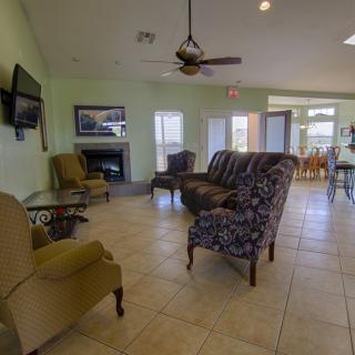 A spacious living room with comfortable seating, a television, and a fireplace.