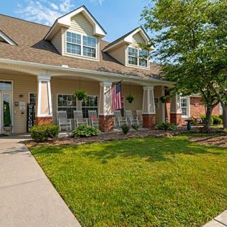 A suburban residential house with a well-maintained lawn and inviting porch.