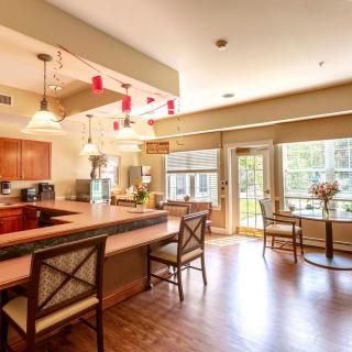 A spacious kitchen and dining area with a large countertop, bar stools, and plenty of natural light.