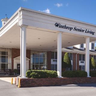 The entrance of Winthrop Senior Living facility on a sunny day.