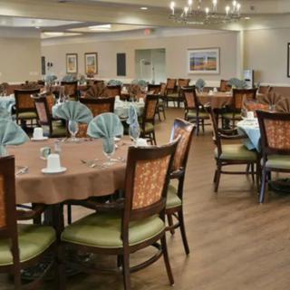 A spacious dining area with neatly arranged tables and elegant place settings.