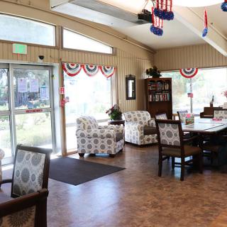 A cozy interior of a lounge area decorated with patriotic-themed banners and comfortable seating.