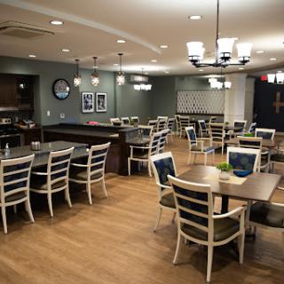 A spacious and modern dining area with wooden floors and stylish furniture.