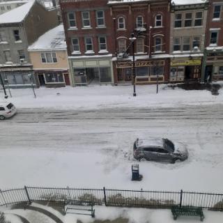 A snowy street scene showcasing quiet urban life during winter.