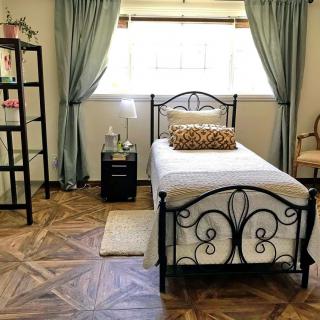 Cozy bedroom with a single bed and elegant decor.