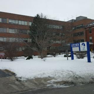 A view of a medical center surrounded by snow in winter.