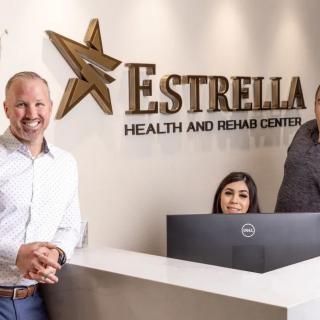 A reception area at Estrella Health and Rehab Center with staff members.