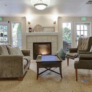 A cozy living room with a fireplace and comfortable seating.