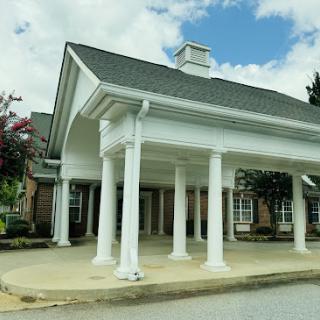 A welcoming entrance featuring classic architectural elements and a beautiful sky.