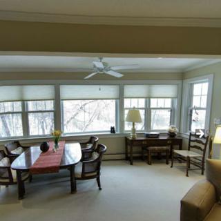 A cozy living room with large windows and elegant furniture.