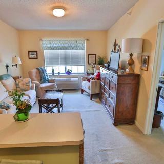 A cozy living room with comfortable seating, a television, and decorative elements.