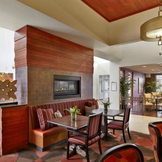 A modern dining area with a cozy fireplace and elegant seating arrangements.